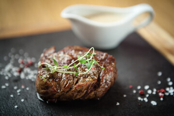 Filet mignon served on a stone board in restaurant