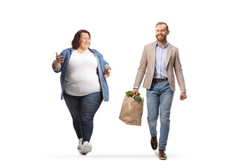 Corpulent woman and a man with grocery bags walking and having a conversation