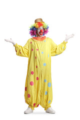 Obraz premium Full length portrait of a clown in yellow costume gesturing welcome with hands