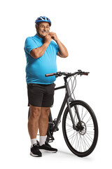 Mature man with a bicycle putting on a helmet