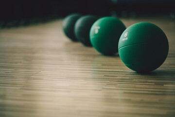medicine ball collection in gym. Medicine balls on wood background. Retro style