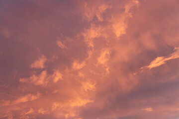 Sunset sky, clouds illuminated by the sun. Warm colors.