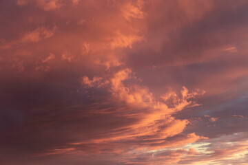 Sunset sky, clouds illuminated by the sun. Warm colors.