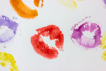 Set of multicolored female lip prints on white paper background top view. Kisses flatly. Lipstick...