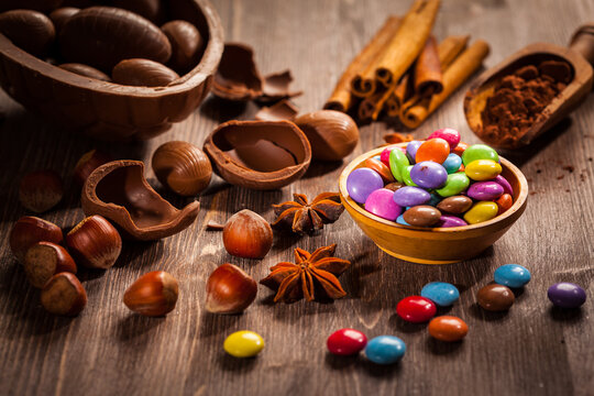 Assorted chocolate eggs for Easter on wooden background