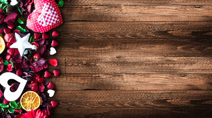 Valentine's Day Background with love themed elements like cotton and paper hearts, flowers, berries, oranges and other decorations. Wooden old parquet on the back.