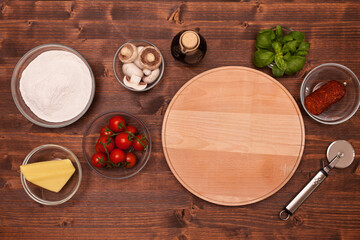 Ingredients and requisites to make a fresh and delicious pizza at home - top view