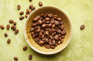 Fresh coffee beans in a bowl, top view. Selective focus