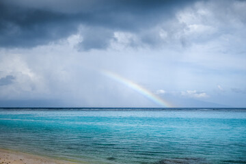Rainbow on Temae Beach lagoon in Moorea island. French Polynesia