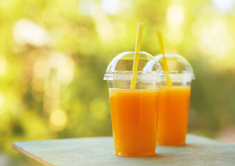 Fresh orange juice in the open air. Selective focus.