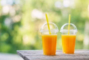 Fresh orange juice in the open air. Selective focus.