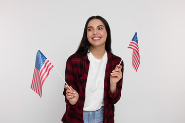 4th of July - Independence Day of USA. Happy woman with American flags on white background