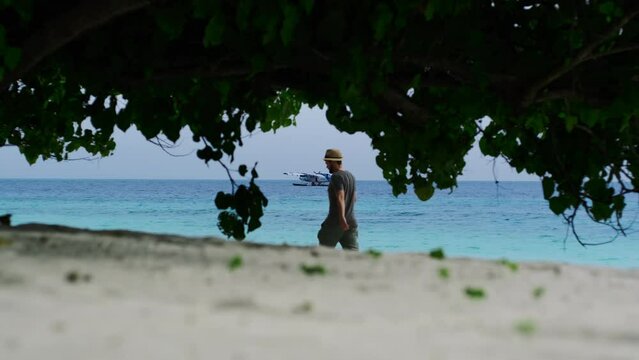 Man Walking On The Beach In Maldives