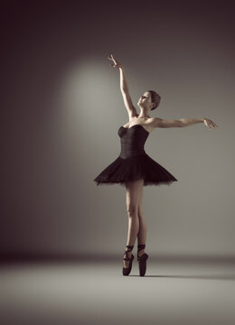 Young and beautiful ballerina posing in a black tutu. This is a 3d render illustration.
