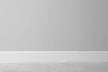 White plinth on laminated floor near wall indoors