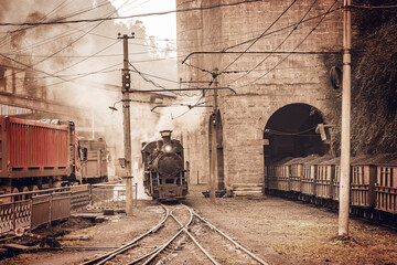 Steam narrow-gauge locomotive stands by the coal loading point. Yuejin. China.