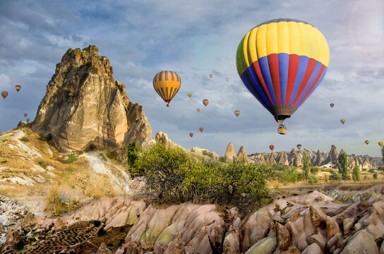 Hot air balloon flying over rock landscape at Cappadocia Turkey in September