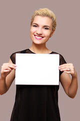 Naklejka premium blond beautiful woman smiling, holding a place for an inscription