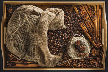 Linen bag with coffee grains, a hank of a cord, a stick of cinnamon, berry of a juniper and fruits...
