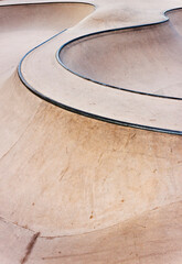 Fototapeta na wymiar Background of an empty bowl with rails in a concrete skate park.