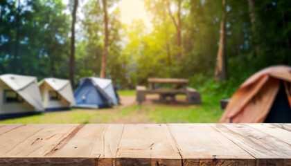 Wood table and Blurred camping and tents in forest.