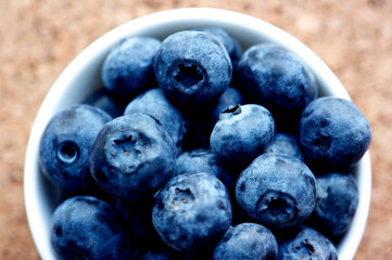 Blueberries on grunge wooden kitchen board close up