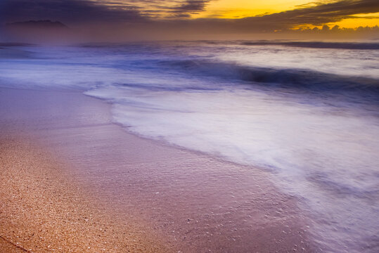 A beautiful sunrise over a deserted beach.