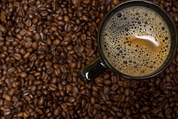 coffee beans background and black cup with hot drink