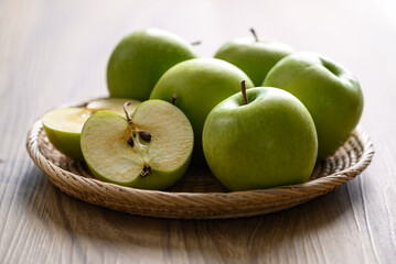 Green apple fruit in basket on wooden background, Healthy fruit
