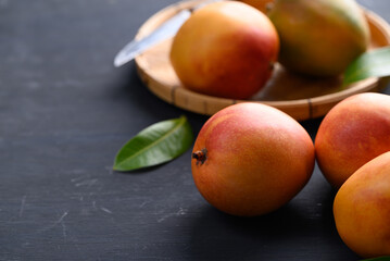 Mango fruit (Tommy Atkins) on black background, Tropical fruit