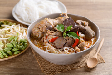 Thai rice noodles curry soup with chicken and coconut milk