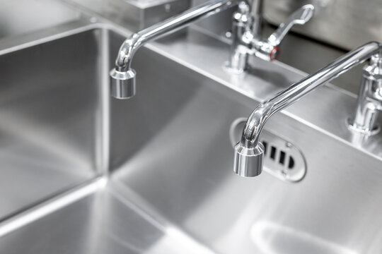 Commercial Sink And Two Faucets In The Kitchen