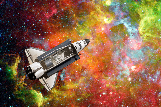 Space Shuttle flight over space nebula. Elements of this image furnished by NASA.
