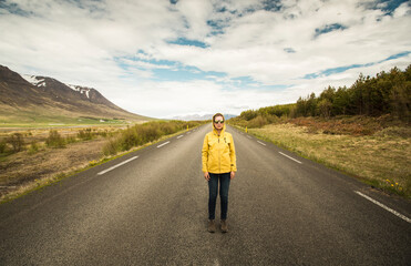 Outddor portrait of a woman in the middle of a beautiful road