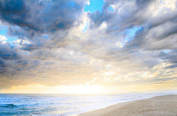 Naklejka na ściany i meble Dramatic cloudy sunset at seaside