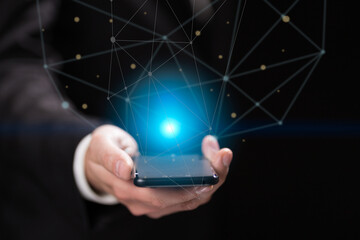 Businessman hand holding blue crystal ball with smartphone