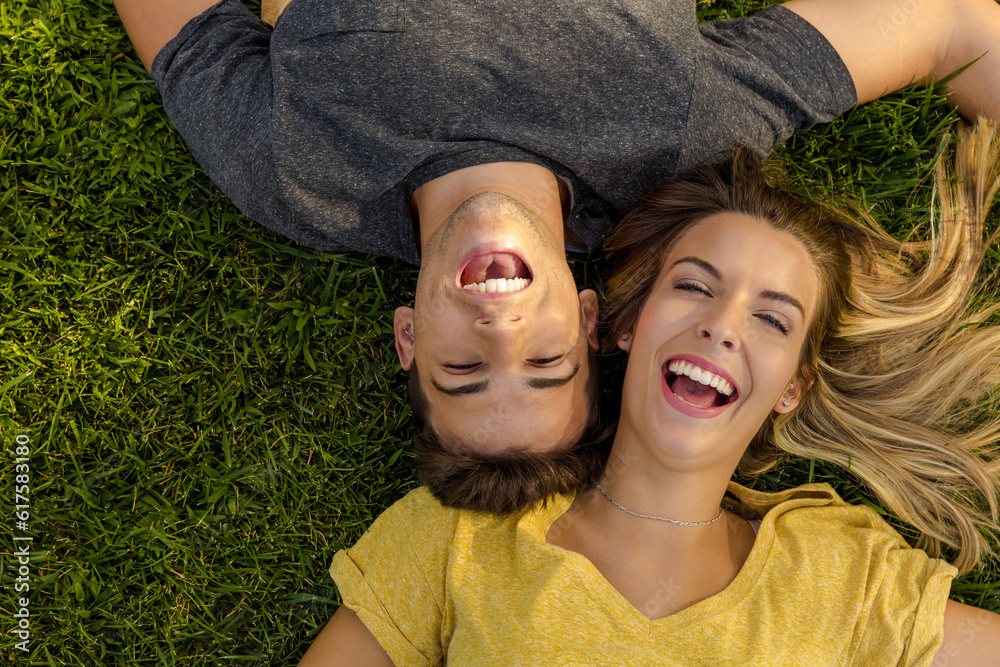 Canvas Prints portrait of a young beautiful couple lying on the grass