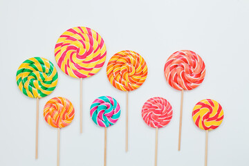 Lollipop candy caramel on sticks on white. Food background. Copy space