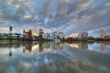 Fototapeta premium Storm Clouds over Portland Oregon city skyline along Willamette River waterfront during sunset