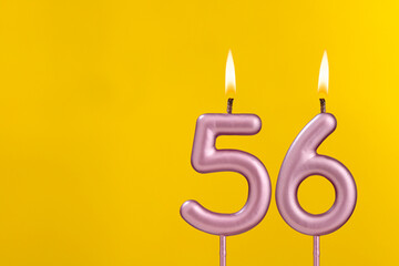 Birthday candle number 56 - Birthday celebration on yellow background