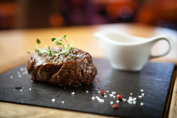 Filet mignon served on a stone board in restaurant