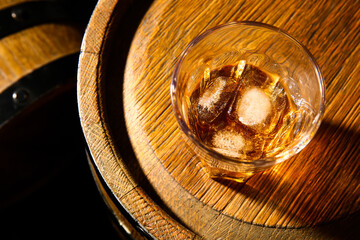 Barrel with glass of cold rum, closeup