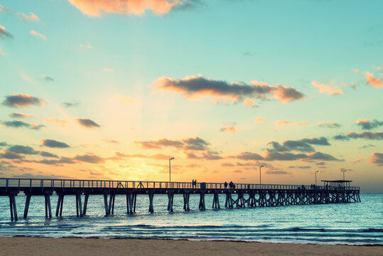 Beautiful sunset at Grange Jetty Adelaide Australia with people silhouettes