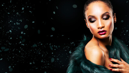 Upscale Indian woman wearing green fur coat and dramatic red lipstick on black background
