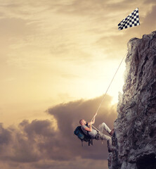 Businessman climb a mountain with a rope to get the flag. Achievement business goal and difficult career concept