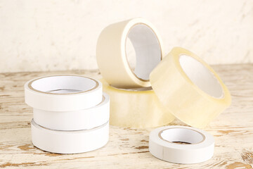 Adhesive tape rolls on light wooden table