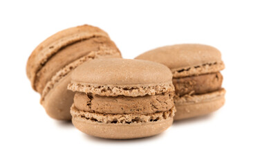 Three brown french macaroon cookies isolated on white background