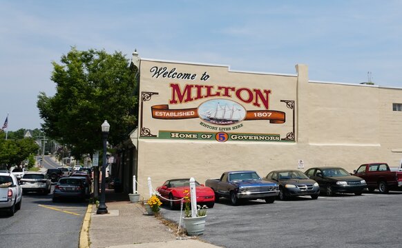 Milton, Delaware, U.S.A - June 18, 2023 - The welcome sign painted on the yellow building