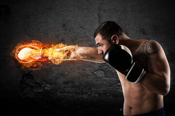 Determined and confident boxer with fiery boxing gloves