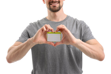 Young man with blank badge making heart on white background, closeup
